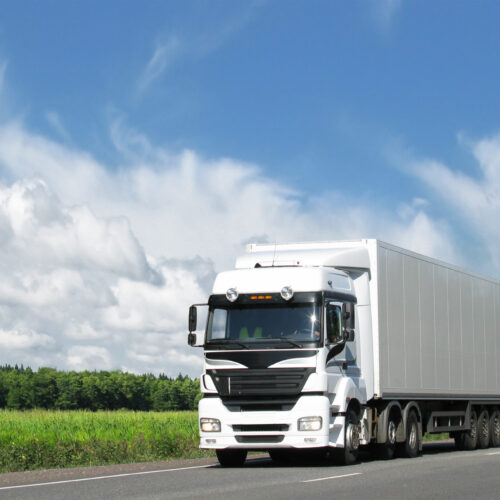 white truck on highway under blue sky